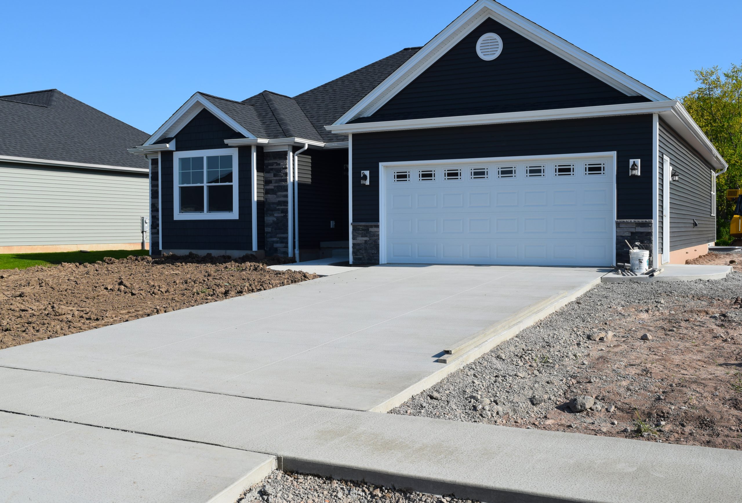 New Concrete Lane and sidewalk in front of a newly constructed home.